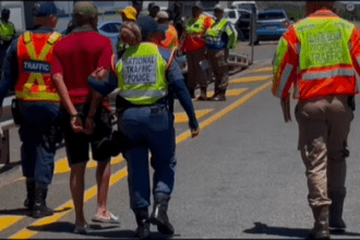 Eastern Cape Traffic Officials Escorting An Arrested Motorist During A Road Block Picture By ECDoT