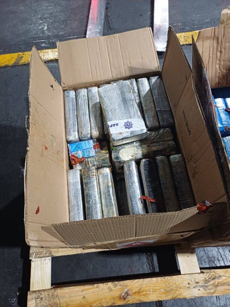 Police officers inspect a cocaine shipment seized at OR Tambo International Airport after a cargo flight arrived from São Paulo, Brazil.